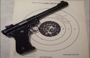 a target pistol laid on a target that has been used